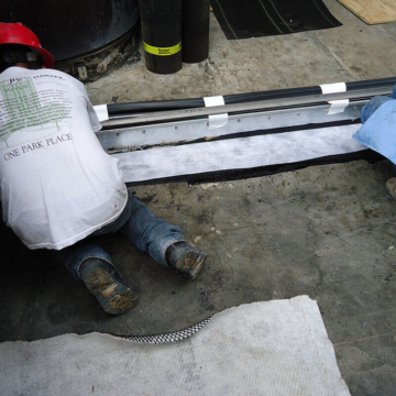 DSM-FP in a plaza to wall expansion joint applying fleece reinforcement layer 