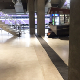 Hinged expansion joint coverplate transition between split columns on a stadium concourse with Wabo®SafetyFlex at Minnesota Viking's US Bank Stadium